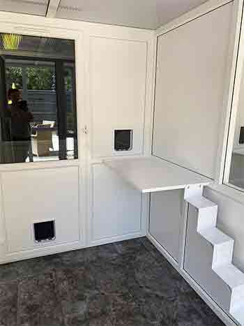 Cattery ladder for elderly cats and two cat flap doors on two different levels leading to the sleeping area